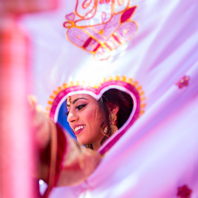 Indian bride is all smiles while getting ready for her wedding