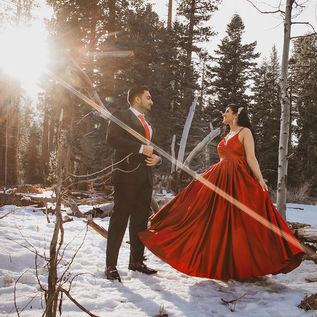 Indian couple wonder the snowy woods in Lake Tahoe during engagement photo shoot
