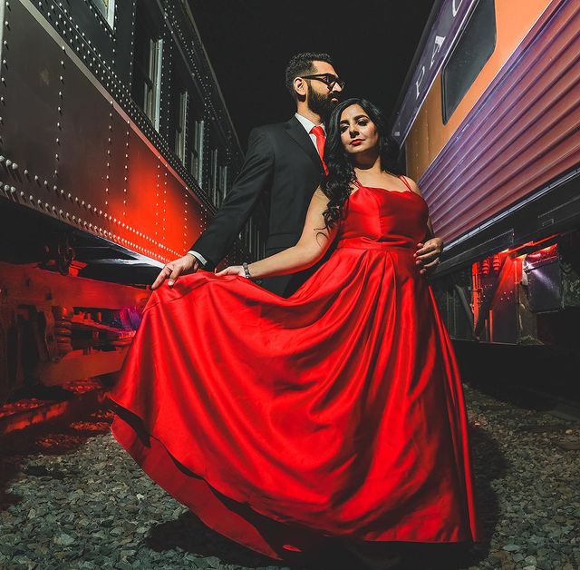 Couple in red dance between train cars in downtown Sacramento